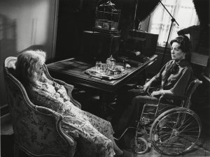 Actress Joan Crawford, sits in wheelchair as actress Bette Davis sits in an armchair facing her pictured at the set in a scene while filming "What Ever Happenend To Baby Jane" in Hollywood, USA, August 1962USA Joan Crawford Bette Davis, HOLLYWOOD, USA