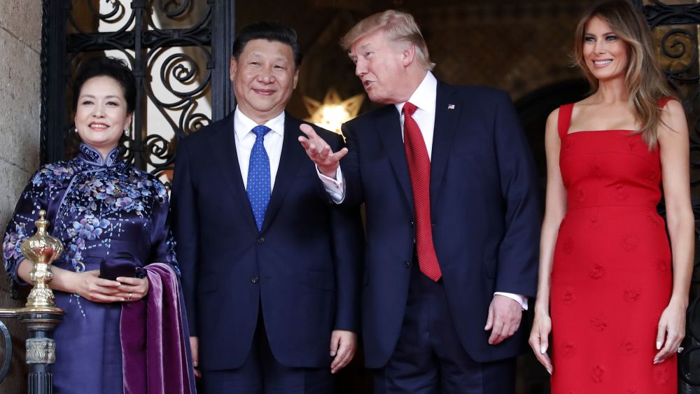 President Donald Trump talks with Chinese President Xi Jinping
