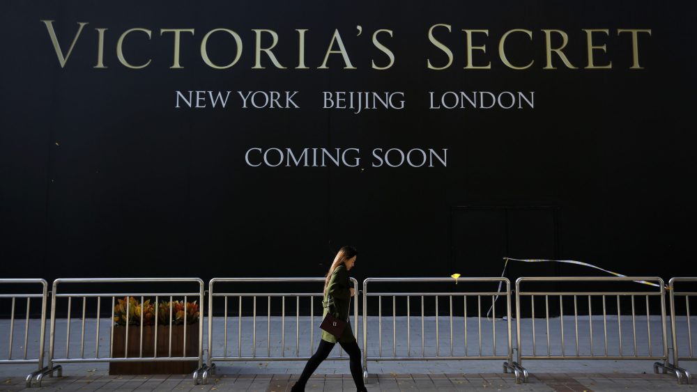 A Chinese woman walks past a Victoria's Secret store under construction in Wangfujing, Beijing.