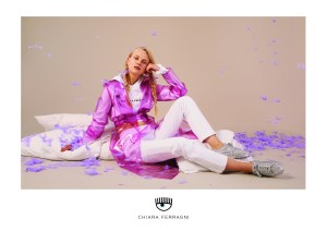 The new Chiara Ferragni spring 2018 ad campaign is dubbed #ChiaraSuite. Images were shot in a studio in Paris by photography duo Florence Tétier and Nicolas Coulomb starring model Anne-Sophie Monrad posing against a beige backdrop, with props including a giant pink pillow. Some of the looks donned by Monrad include a palm-printed silk pajama set and a fuchsia PVC trenchcoat, as well as crystal embellished golden slippers and over-the-knee black boots, both featuring a palm tree. Ferragni emphasized "the neutral setting of the campaign" that helps concentrate the attention on the product. — Martino Carrera