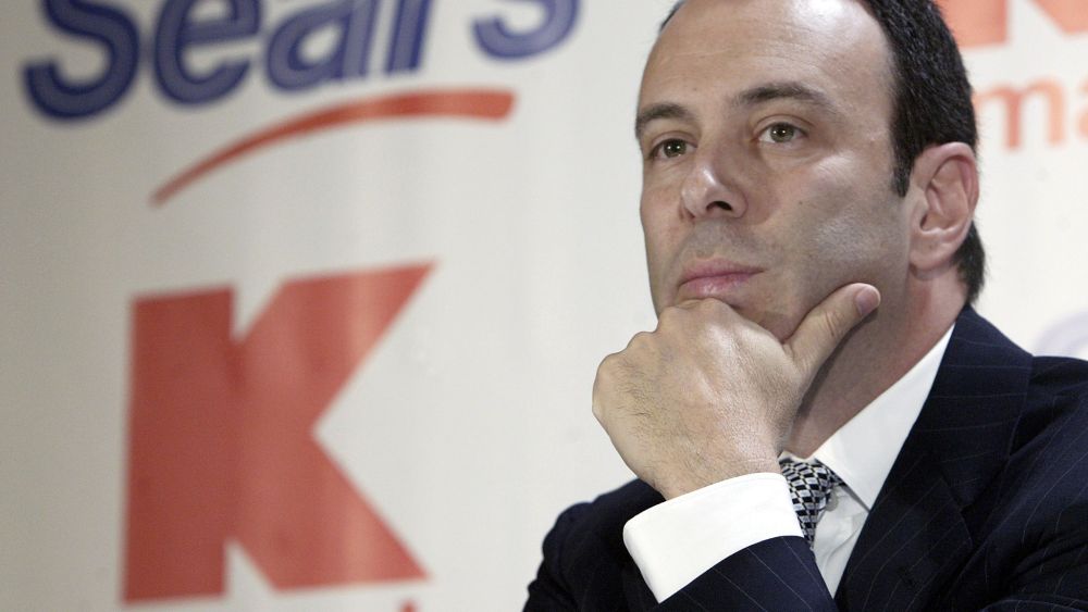Kmart chairman Edward Lampert listens during a news conference to announce the merger of Kmart and Sears in New York , 2004.