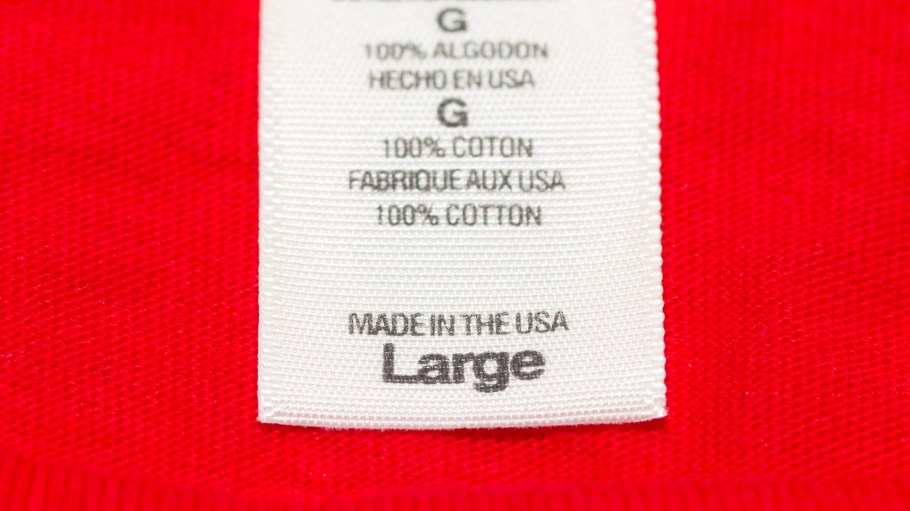Close up "Made in the USA" clothes label on a large red t-shirt. Shot with macro lens.