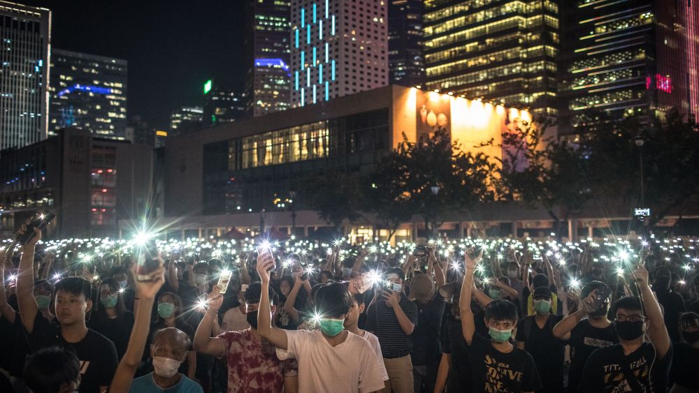 Students wave their phone at a protest in Hong Kong on Thursday, August 22, 2019.