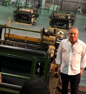Vidalia Mills CEO Dan Feibus flipped the switch on a selvedge denim weaver, one of 40 purchased from Cone Denim to be used at the facility.