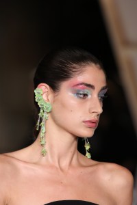 The vibe was "painterly," said Erin Parsons, who led makeup for Maybelline. To get the look, Parsons mixed custom shades of pink, blue and sea foam green and used her fingers to smear the shadow across models' lids, and the heel of her palm to push splashes of color up through the eyebrow. The makeup was similar for girls and boys. "We're doing sort of smaller versions on the boys, which kind of feels David Bowie-esque, which I really love. It's really working well on themÉthere are certain ones that look hot," Parsons said. Ñ Allison Collins