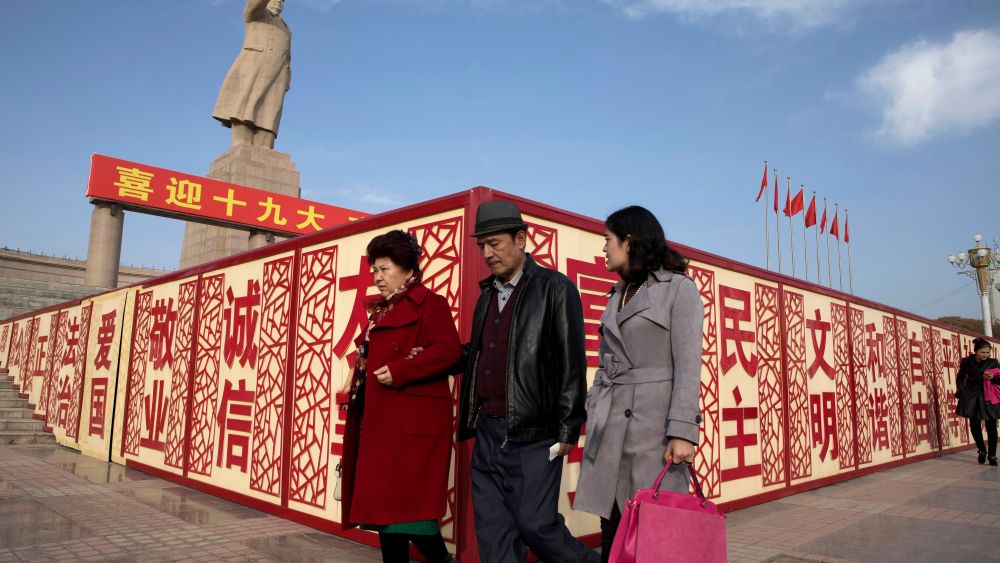 Residents walk past a statue showing Mao Zedong near billboards with the words for "Welcome 19th Congress," "Patriotism" and "Democracy" near a square in Kashgar in western China's Xinjiang region. Authorities are using detentions in political indoctrination centers and data-driven surveillance to impose a digital police state in the region of Xinjiang and its Uighurs, a 10-million strong, Turkic-speaking Muslim minority Beijing fears could be influenced by extremismDigital Police State, Kashgar, China - 04 Nov 2017