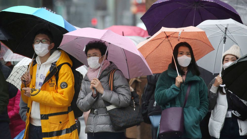 People wear masks at shopping district.