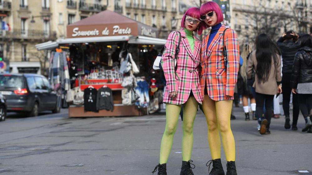 Ami Suzuki and Aya Suzuki don Dr. Martens with colorful ensembles at Paris Fashion Week last March. At Platform in Las Vegas Wednesday, NPD's Beth Goldstein said 2020 footwear trends will focus on casual comfort and utilitarian design.