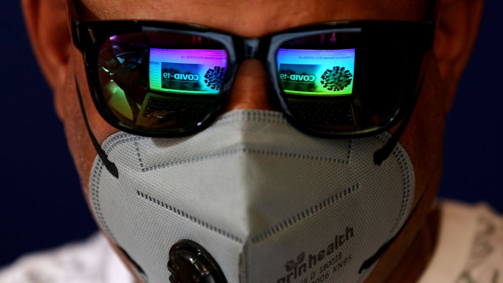 The screen of a laptop showing news about COVID-19 is reflected in the sunglasses of a man wearing a mask as a precaution against the coronavirus outbreak, in Bangalore, India, 04 March 2020. A 25-year-old software engineer from Bangalore is currently being tested after showing symptoms of a potential coronavirus infection. According to media reports, at least 15 Italian tourists and their Indian driver have tested positive for COVID-19.Preventative measures against novel coronavirus outbreak, in Bangalore, India - 04 Mar 2020
