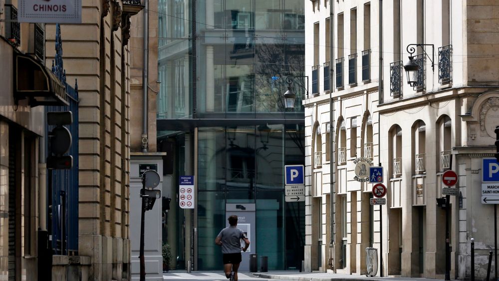 Man runs in an empty street of Paris