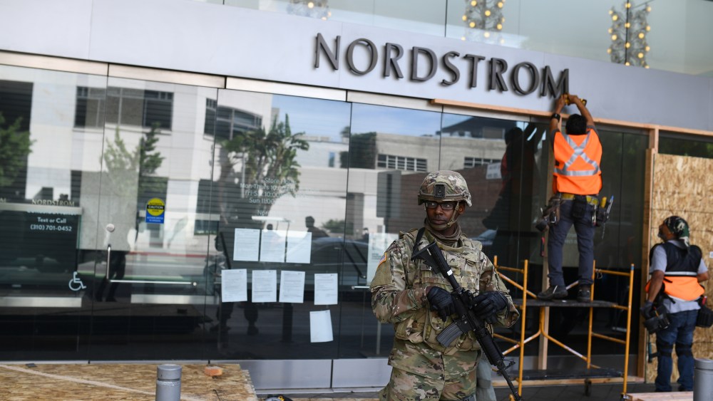 Nordstrom in Santa Monica under the watch of National Guard as its boarded up Monday.