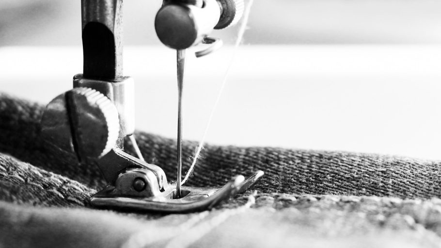 Close-up detail of the sewing machine, jeans