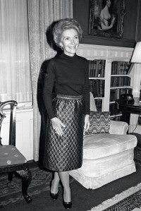 Nancy Reagan in 1980, a short time before assuming the role of First Lady, wearing an Adolfo purple quilted rainskirt and black turtleneck while standing in Blair House, the official guest residence of the President-elect before moving into the White House.