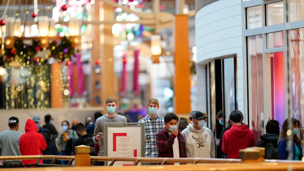 Last-minute shoppers wear face masks as they search for Christmas Eve deals in Park Meadows Mallin Lone Tree, Colorado.