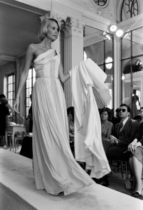 A model walks the runway in a grecian-inspired two toned column dress from Madame Gres fall 1974 couture collection.