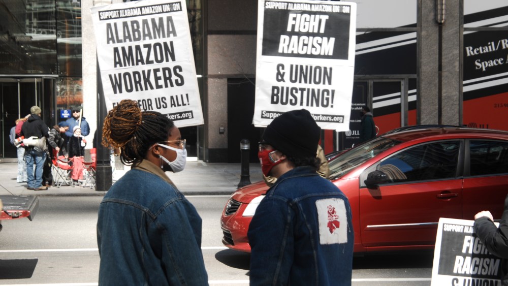 Protesters rally support from drivers as they pass by a rally in support of unionizing Amazon workers in Bessemer, Alabama in front of the law office of Morgan and Lewis during a national day of action in Philadelphia, PA, on March 20, 2021. Morgan and Lewis are known for their union-busting activities and are assisting Amazon in its efforts to bust up the unionizing efforts in Bessemer, Alabama. (Photo by Cory Clark/NurPhoto via AP)