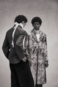 Left: Dior Men’s wool and mohair jacket and Valentino’s TK pants. Agmes earring; Philosophy ruffle neck collar.Right: Dior Men’s cotton and silk coat, Celine Homme by Hedi Slimane’s cotton shirt and Ami’s virgin wool pants. Givenchy necklace.