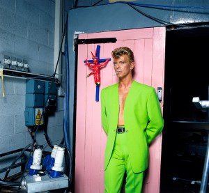 David Bowie during the making of the video for the Tin Machine song "You Belong in Rock 'n' Roll" wearing a look from the ready-to-wear spring/summer 1992 collection.