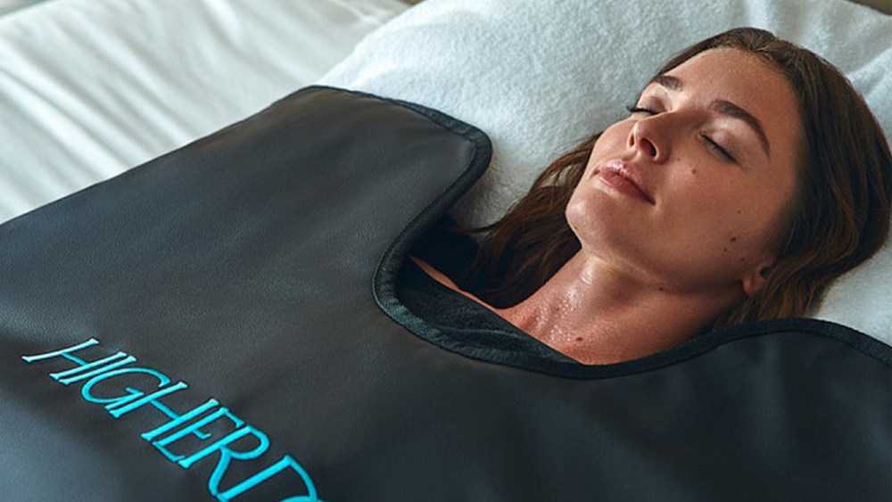 Woman laying in the HigherDose infrared sauna blanket