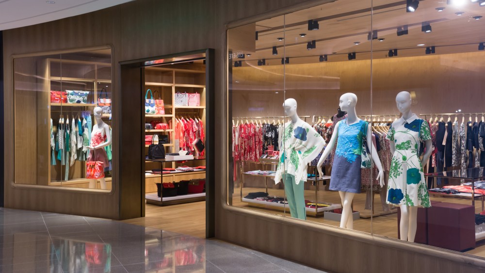 mannequins in dresses in store window