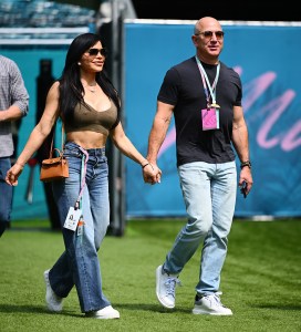 Jeff Bezos and Lauren Sanchez walk in the Paddock prior to final practice ahead of the F1 Grand Prix of Miami at Miami International Autodrome on May 06, 2023 in Miami.