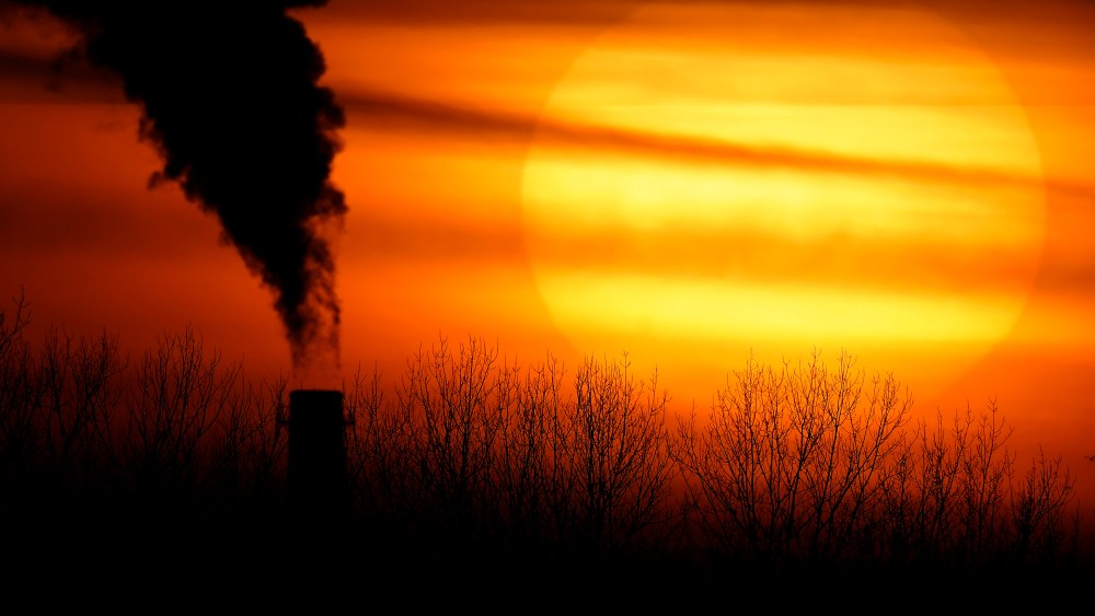 FILE - Emissions from a coal-fired power plant are silhouetted against the setting sun in Kansas City, Mo., Feb. 1, 2021. The Supreme Court on Thursday, June 30, 2022, limited how the nation’s main anti-air pollution law can be used to reduce carbon dioxide emissions from power plants. By a 6-3 vote, with conservatives in the majority, the court said that the Clean Air Act does not give the Environmental Protection Agency broad authority to regulate greenhouse gas emissions from power plants that contribute to global warming. (AP Photo/Charlie Riedel, File)