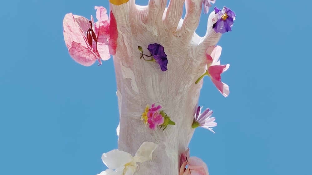 The artist uses simple objects like flowers to create her designs.