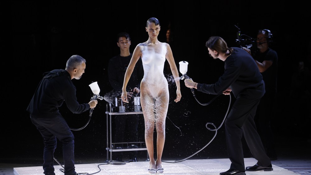 Bella Hadid is spray-painted with a liquid fabric on the Coperni runway at Paris Fashion Week.