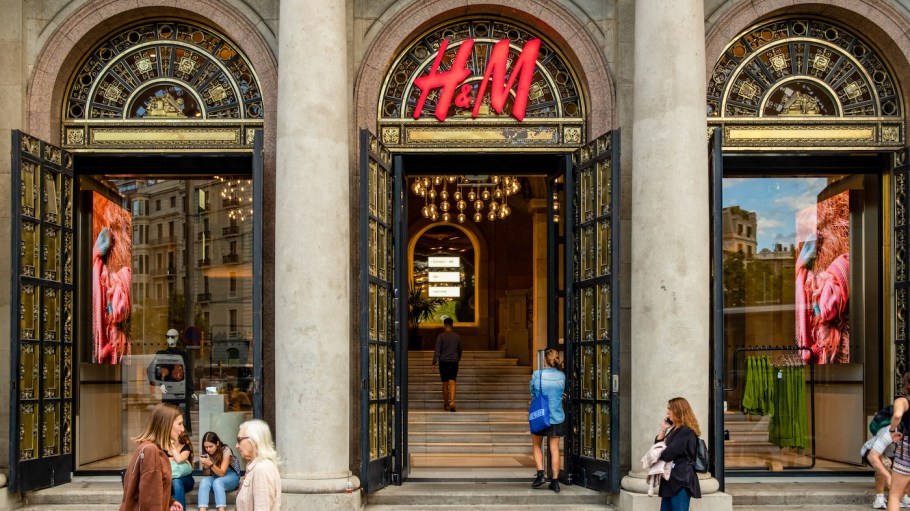 The logo of the fast fashion clothing brand H&M is seen on top of store entrance.