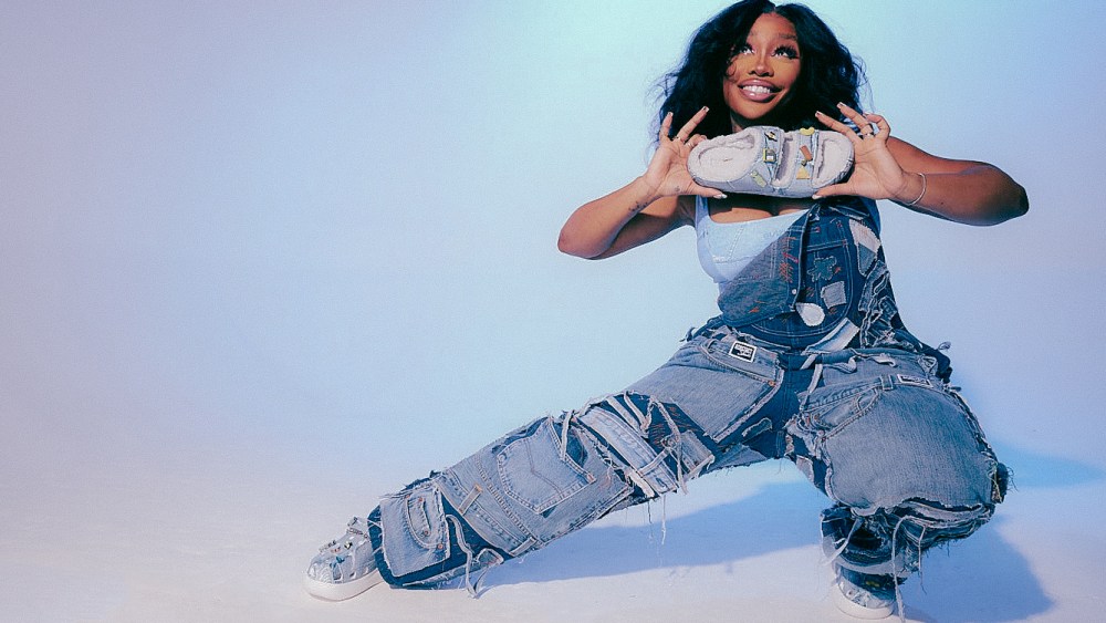 SZA holding a Croc shoe from her latest collaboration with Crocs.