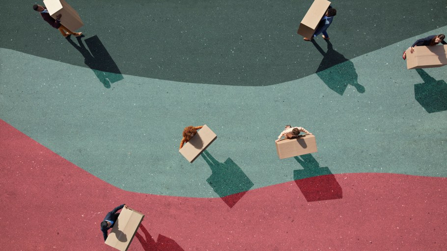 Group of young adults holding boxes, photographed from above, on various painted tarmac surface, at sunrise.