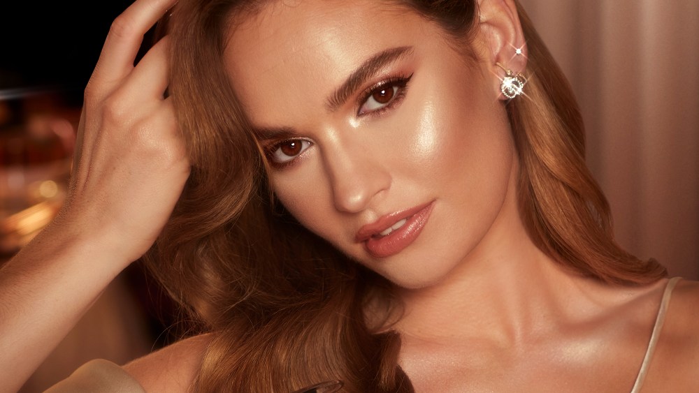 Lily James in the Charlotte Tilbury Hollywood Glow Glide Face Architect Highlighter campaign.