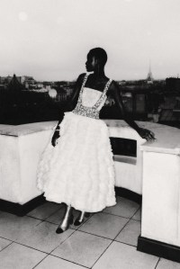 Chanel’s couture organza bustier over silk tulle embroidered with deer and foliage motif by Paloma, skirt embellished with a mille-feuille of organza made by the atelier, peplum and straps in silk tulle embroidered with floral motifs, leather and patent boots. Chanel High Jewelry Attirante bracelet in 18-karat white gold set with brilliant-cut diamonds and 18k white gold ring set with diamonds.