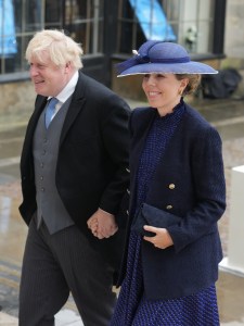 LONDON, ENGLAND - MAY 06: Former British Prime Minister Boris Johnson and and Carrie Johnson arrive ahead of the Coronation of King Charles III and Queen Camilla on May 6, 2023 in London, England. The Coronation of Charles III and his wife, Camilla, as King and Queen of the United Kingdom of Great Britain and Northern Ireland, and the other Commonwealth realms takes place at Westminster Abbey today. Charles acceded to the throne on 8 September 2022, upon the death of his mother, Elizabeth II. (Photo by Dan Charity - WPA Pool/Getty Images)