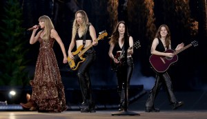 Taylor Swift, Christian Louboutin, boots, brown boots, suede boots, heels, high heels, block heels, womens boots, western boots, cowboy boots, Etro, dress, brown dress, sequins, sequined dress, HAIM, Alana Haim, Este Haim, Danielle Haim, Eras, Era Tour, concerts, concert tour