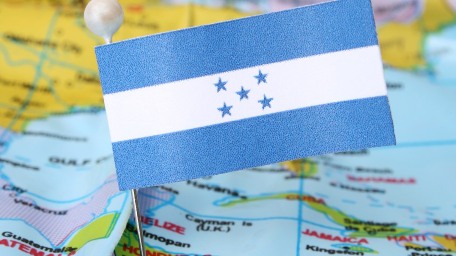 The Honduras flag on a map of Central America and the Caribbean.