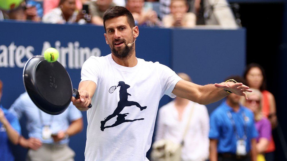 NEW YORK, NEW YORK - AUGUST 26:  Novak Djokovic of Serbia plays tennis with a frying pa as a racket during Arthur Ashe Kids' Day at USTA Billie Jean King National Tennis Center on August 26, 2023 in New York City. (Photo by Clive Brunskill/Getty Images)
