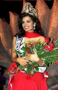 WINDHOEK, NAMIBIA - MAY 12:  Miss USA, Chelsi Smith is crowned the Miss Universe 95 at the Windhoek Country Club 13 May in Namibia during a live telecast. The two runners-up in the contest were Miss India, Manpreet Braar and Miss Canada, Lana Buchenberger.   AFP PHOTO  (Photo credit should read PHILIP LITTLETON/AFP via Getty Images)
