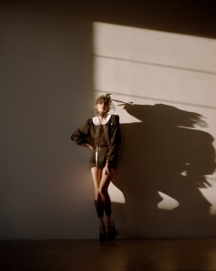 Maison Margiela black bin liner and tulle hat, black wool romper with a white cotton padded col claudiner, gloves, tights and shoes; Eéra Dimitri chain in 18-karat gold with white diamonds (worn as a belt).