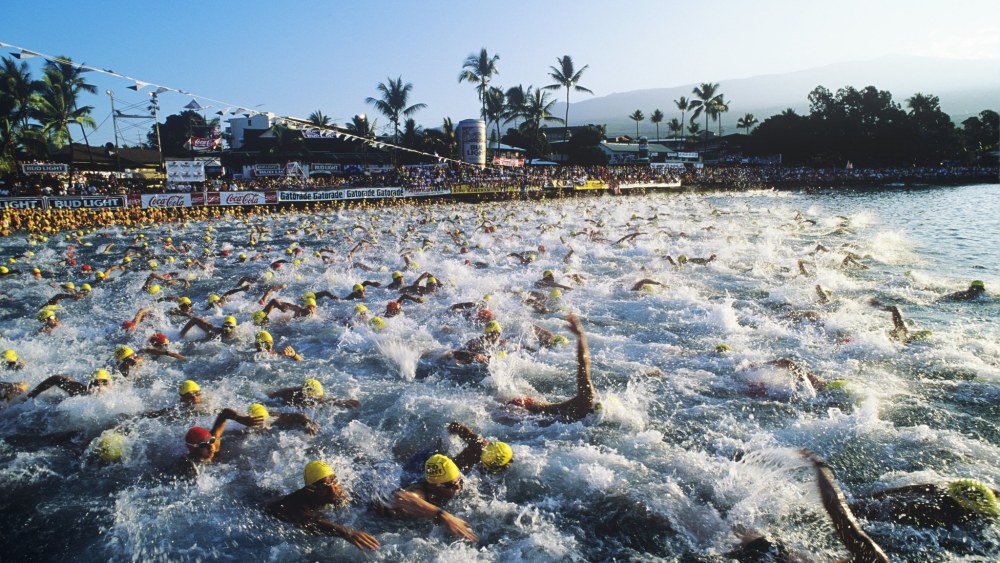 KONA, HI - OCTOBER 1990:  Participants swim past during the start of the 1990 Ironman Triathlon in October 1990 in Kona, Hawaii. (Photo by John Kelly/Getty Images)
