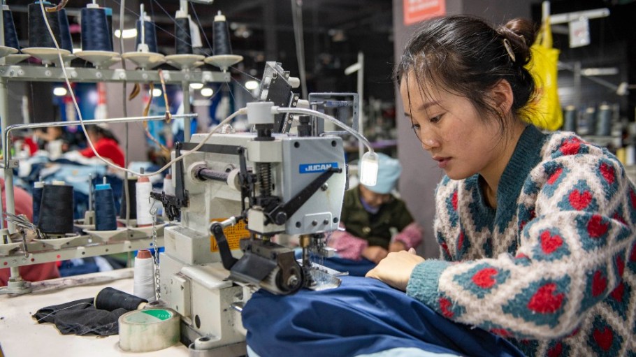 Workers produce garments at a workshop of a garment company in Guizhou Province, China.