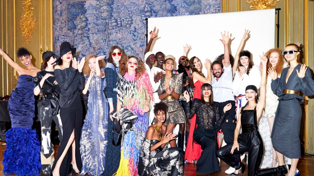 Ronald van der Kemp surrounded by models sporting his fashion.