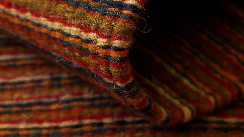 At Handmade.com: ‘Fire Walk’. Narrow paths in fiery colors align in this rug by artisan Alfredo Ruiz in Mexico, which he has meticulously hand-loomed in traditional Zapotec indigenous style. Red, beige, green, blue and yellow mingle with black, burgundy and orange hues. 6.5'L x 4.3’W. 100% wool. All natural dyes. $489.99. Photo courtesy Handmade.com.