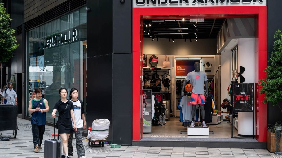 Shoppers walk past the American multinational clothing brand Under Armour store in Hong Kong.
