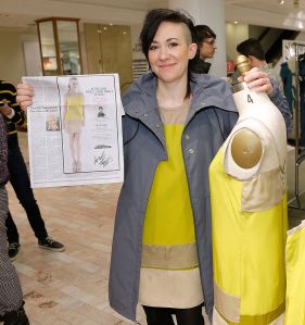 NEW YORK, NY - MARCH 22:  Designer Michelle Franklin holds a newspaper insert as she poses with her Project Runway Lord & Taylor challenge during an in-store at the Lord & Taylor Flagship store on March 22, 2013 in New York City.  (Photo by Jemal Countess/WireImage)