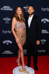 NEW YORK, NEW YORK - MAY 16: Chrissy Teigen (L) and John Legend attend the 2024 Sports Illustrated Swimsuit Issue launch party at Hard Rock Cafe - Times Square on May 16, 2024 in New York City. (Photo by Gotham/FilmMagic)