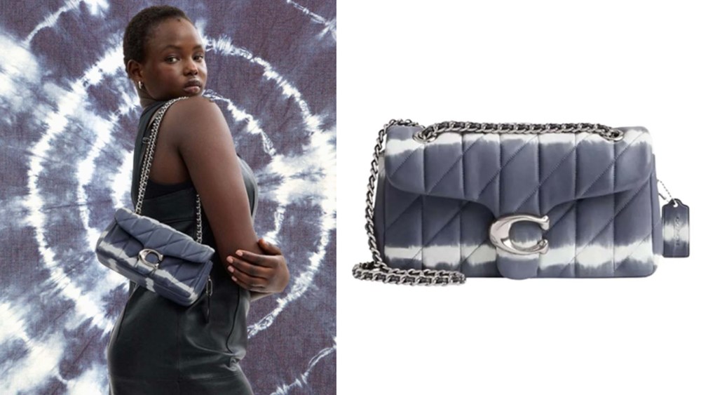 model wearing tie dye shoulder bag in front of blue tie dye background; blue and white dyed handbag with chain strap