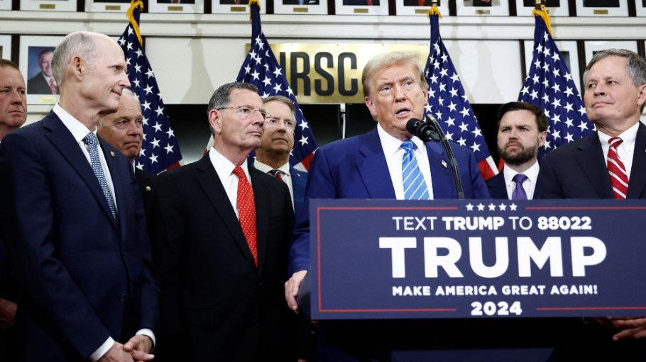 Donald Trump with Senate Republicans as he gives remarks to the press at the National Republican Senatorial Committee building on June 13.