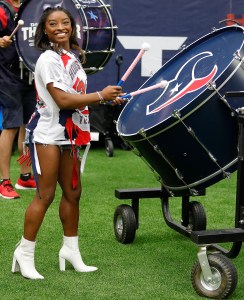 HOUSTON, TEXAS - OCTOBER 02: Simone Biles participates in pregame activity before the Houston Texans play the Los Angeles Chargers at NRG Stadium on October 02, 2022 in Houston, Texas. (Photo by Bob Levey/Getty Images)