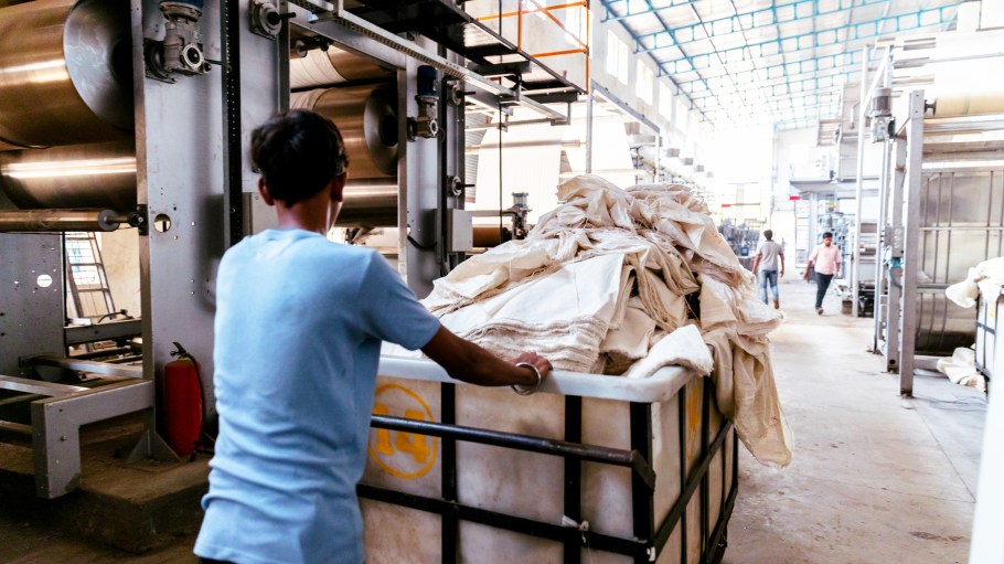 A factory worker pushing to the fabric dyeing machine